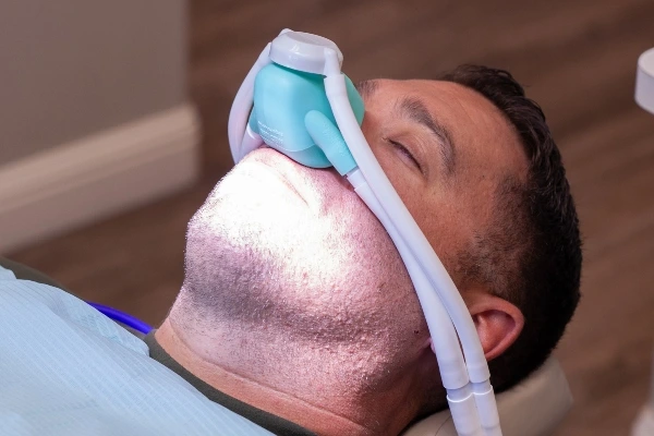 Young female patient with open mouth examining dental inspection at dentist